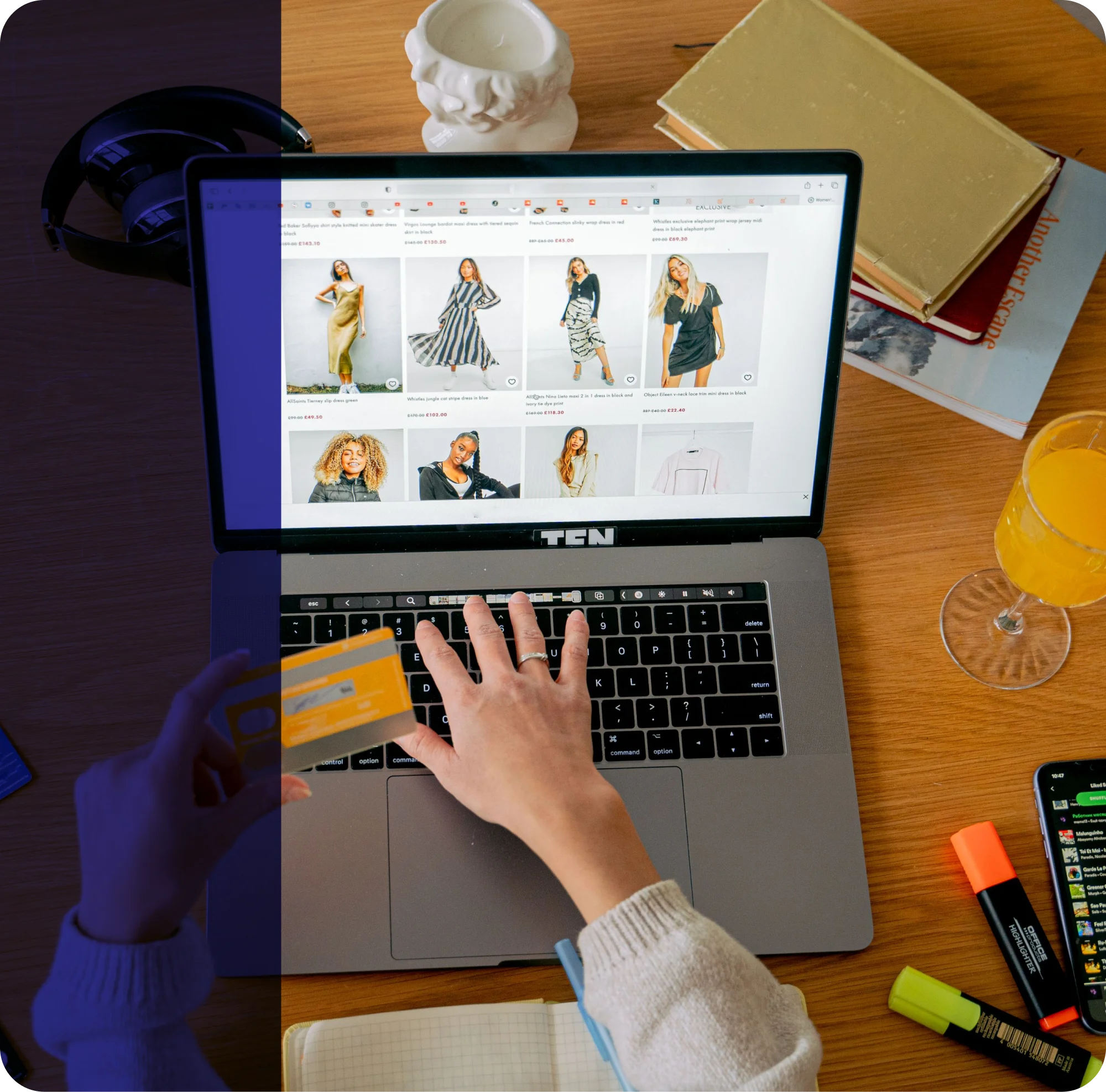 Laptop screen showing a clothing catalog while a user checks out with credit card payment details.