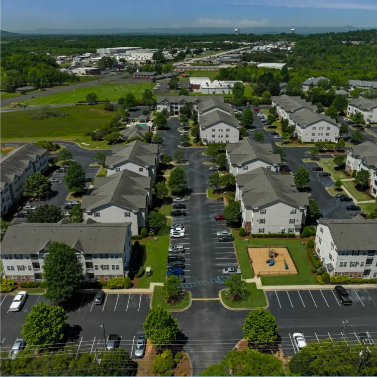 High-angle aerial photo of a multi-family residential property complex, illustrating professional real estate and property management services.